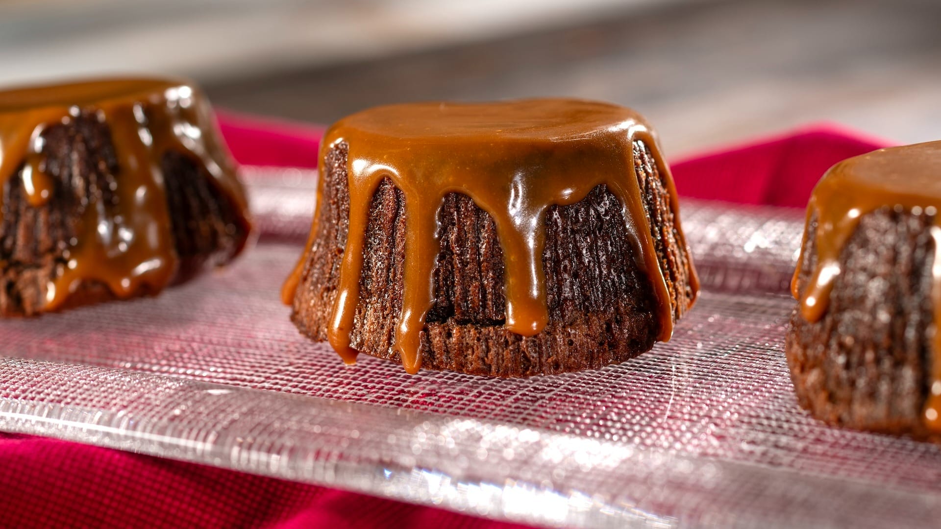 Chocolate lava cakes with caramel sauce, featured on the 2025 menus at the EPCOT Food & Wine Festival.
