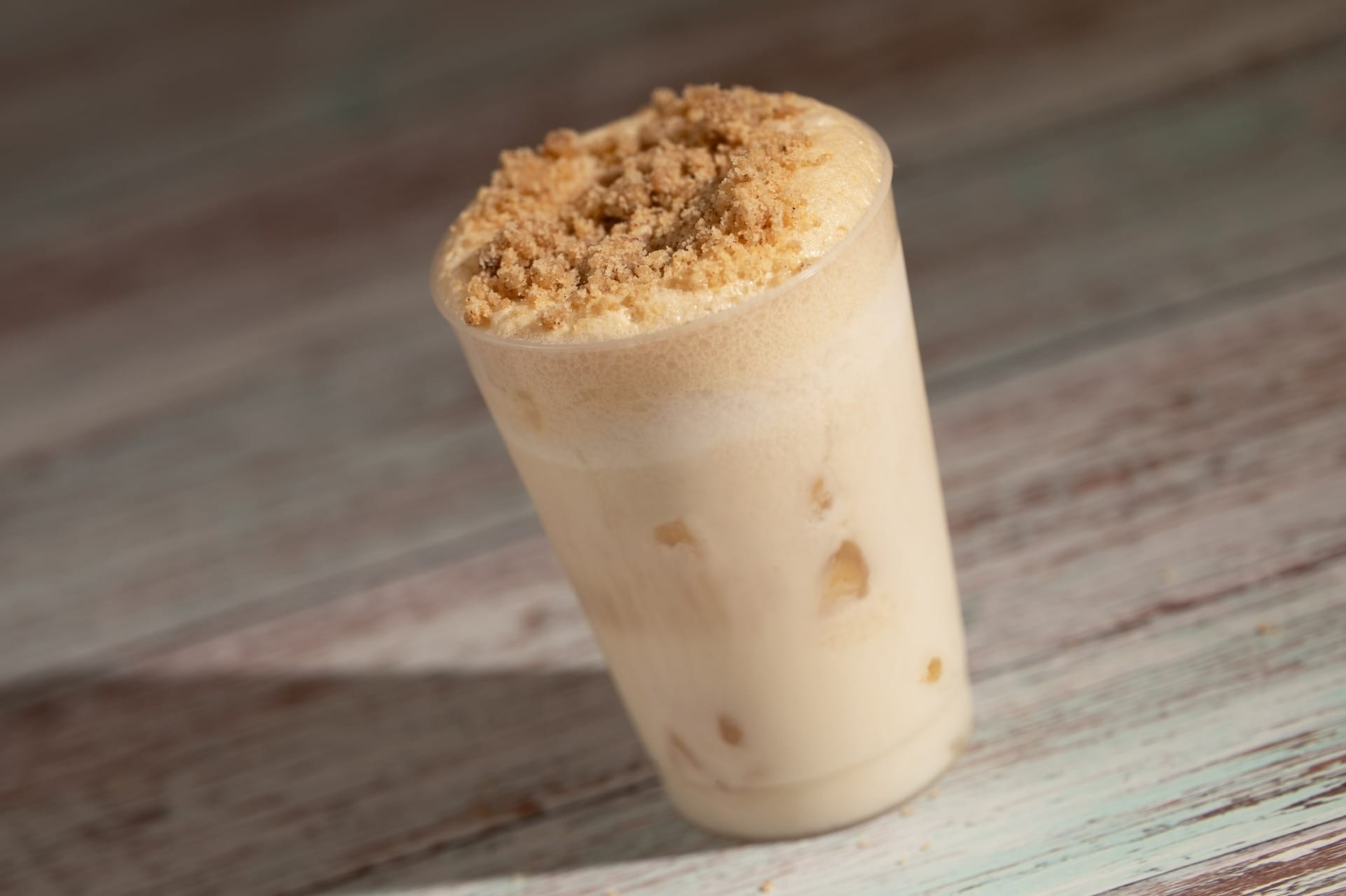 Iced coffee drink topped with cookie bits, inspired by 2025 menus at the EPCOT Food & Wine Festival.