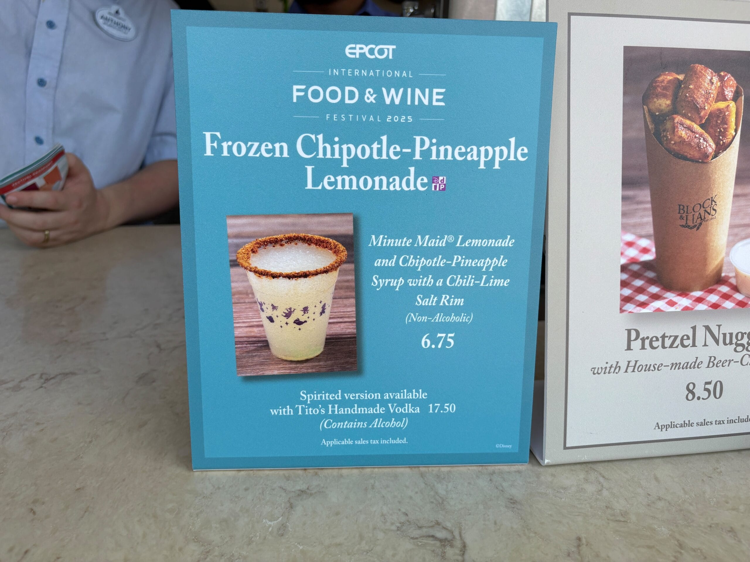 A sign displays Frozen Chipotle-Pineapple Lemonade with a chili-lime salt rim at the Food & Wine Festival.