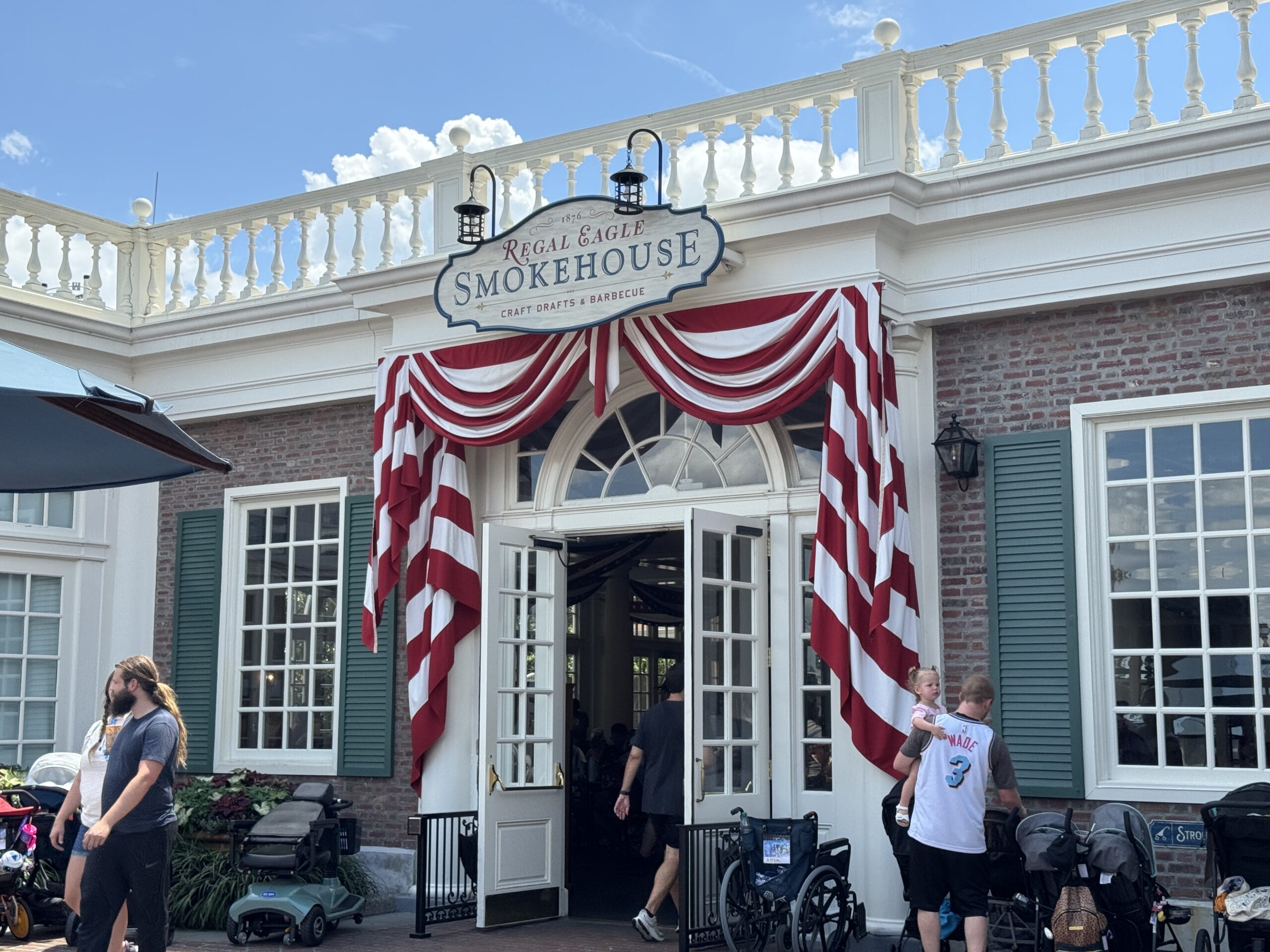 Regal Eagle Smokehouse welcomes guests with red and white bunting—try delicious New Food & Wine offerings inside!