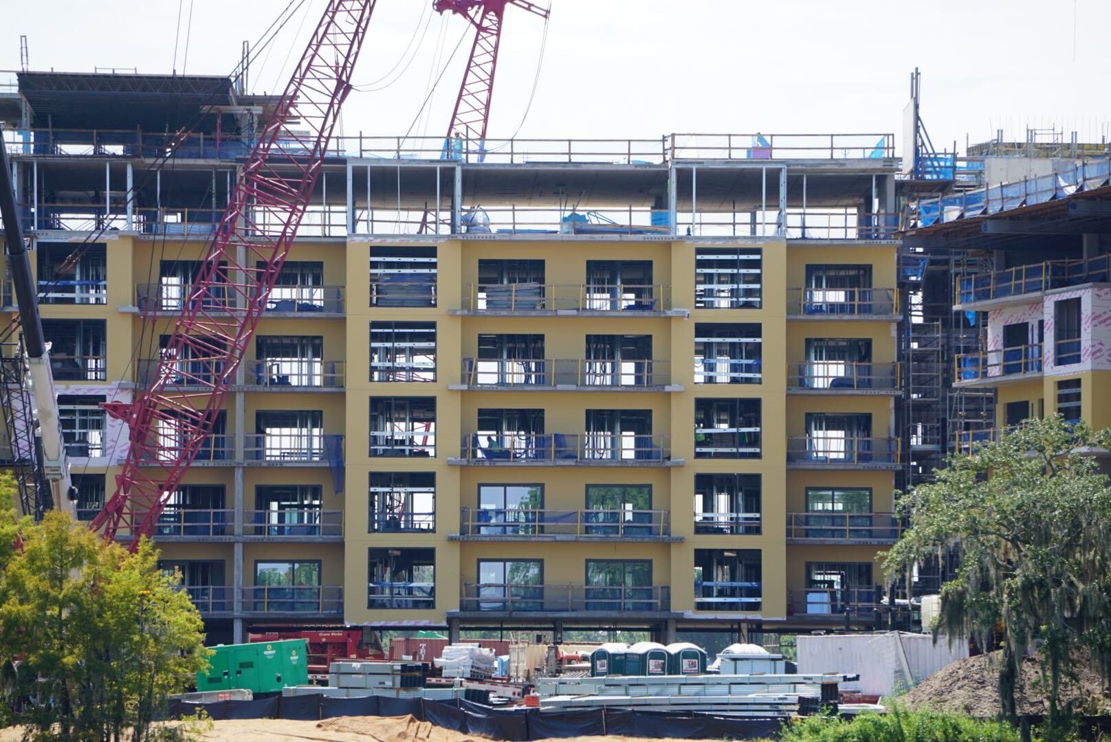 Lakeshore update: Yellow multi-story building under construction with cranes and equipment in front.