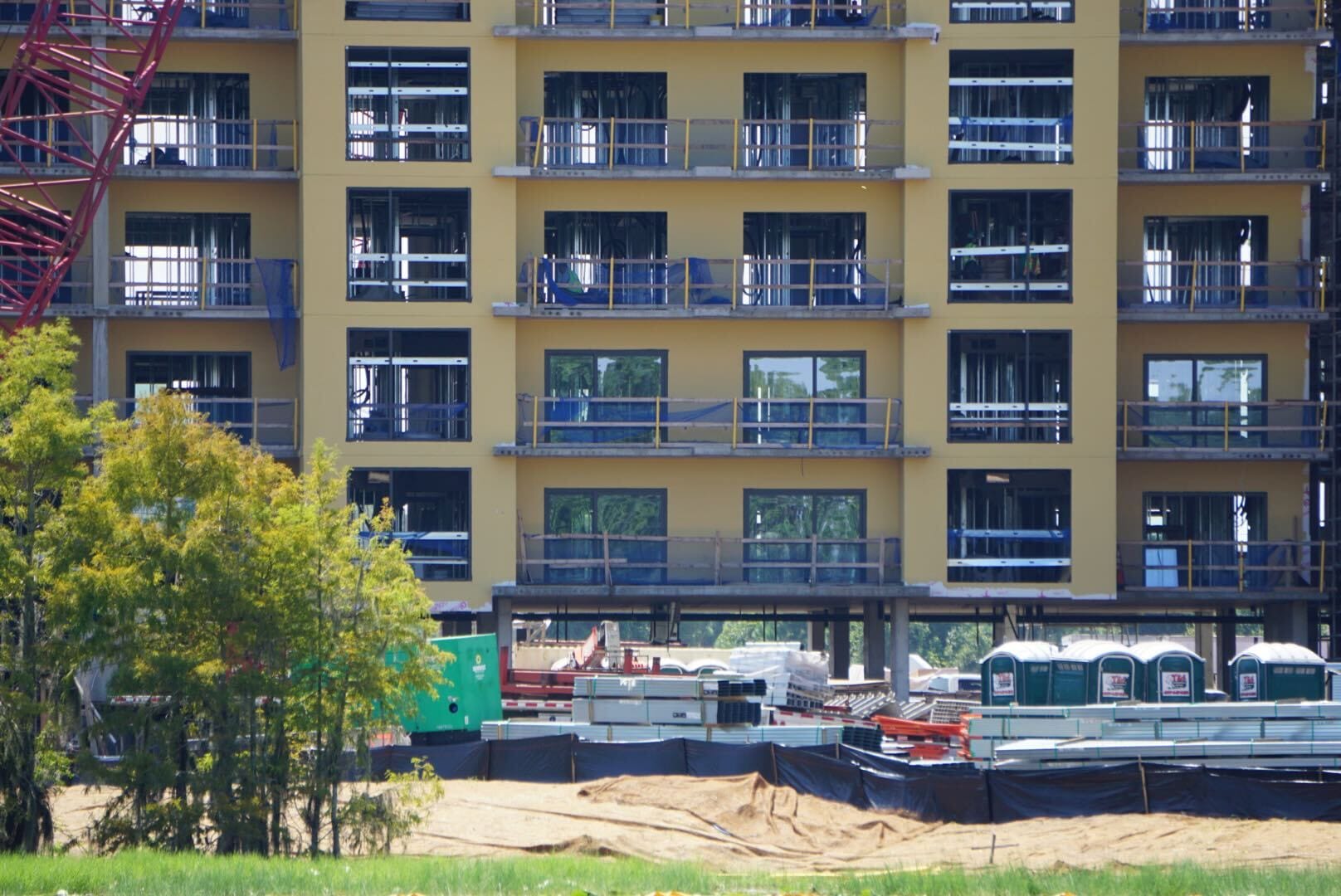 Lakeshore Update: A multi-story building under construction with exposed windows, materials, and portable toilets in front.