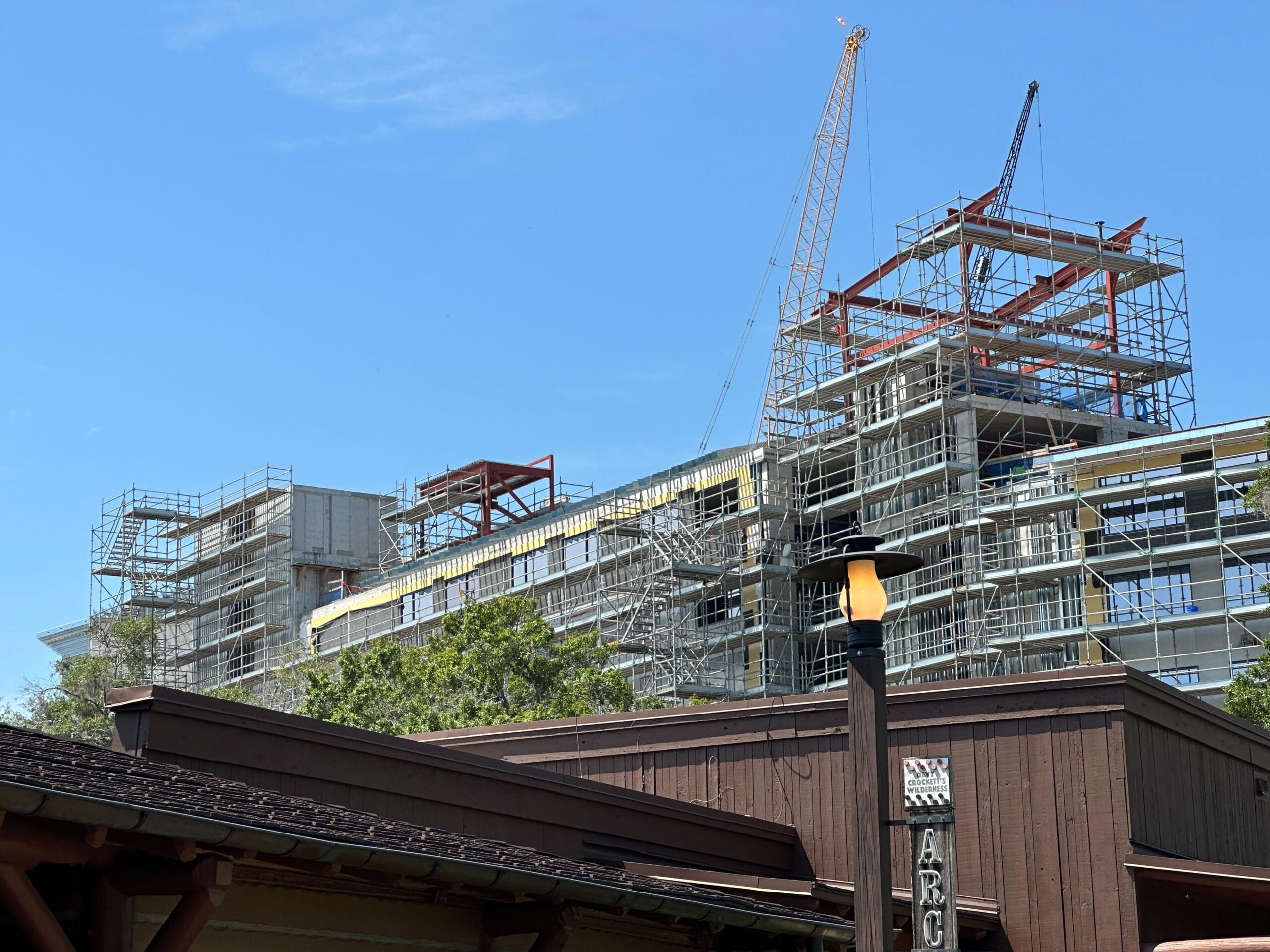 A multi-story building under construction rises behind a wooden structure and lamp post in this Lakeshore Update.