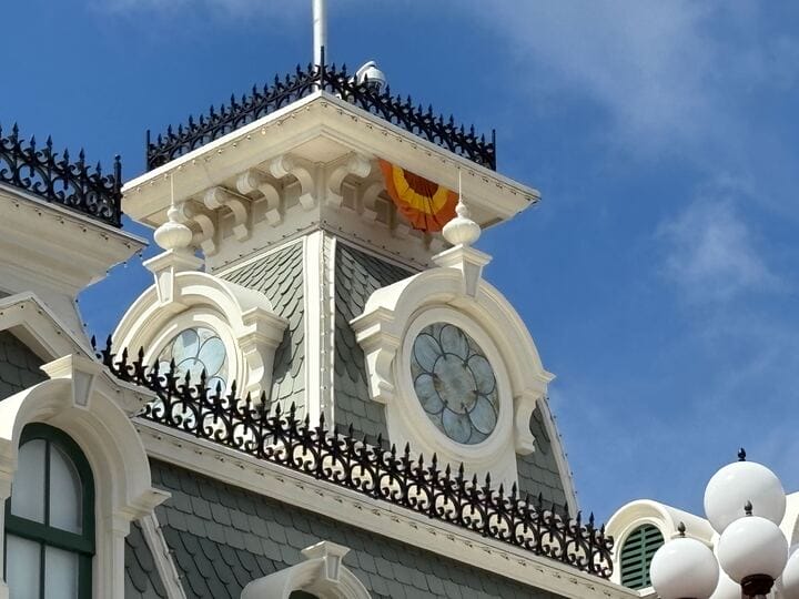 Close-up of a rooftop with ornate trim, round windows, and Halloween Decor at Magic Kingdom’s Mickey’s Not So Scary Halloween Party 2025.