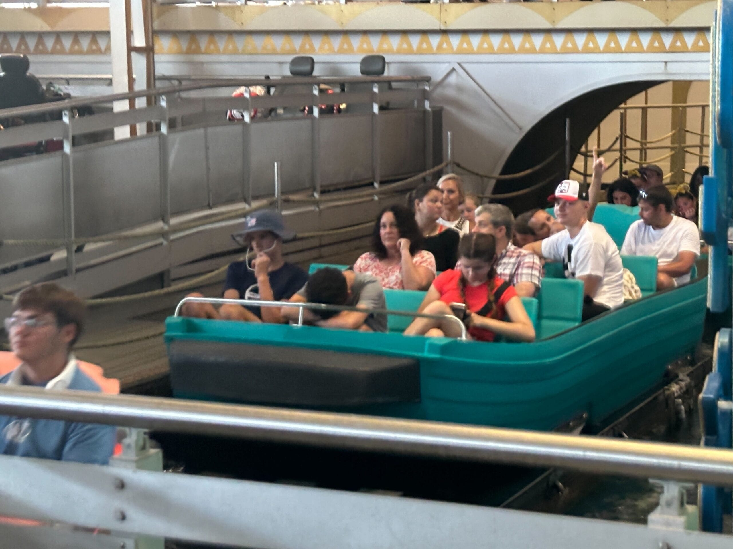 Guests sit in new boats on the it’s a small world ride, waiting to depart inside Magic Kingdom’s beloved attraction.