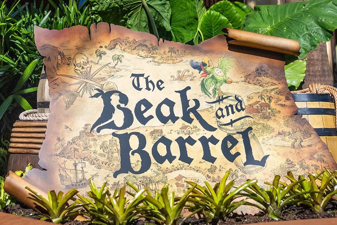 A weathered Sign reads "The Beak and Barrel" with a parrot, plants, and barrels in the background.