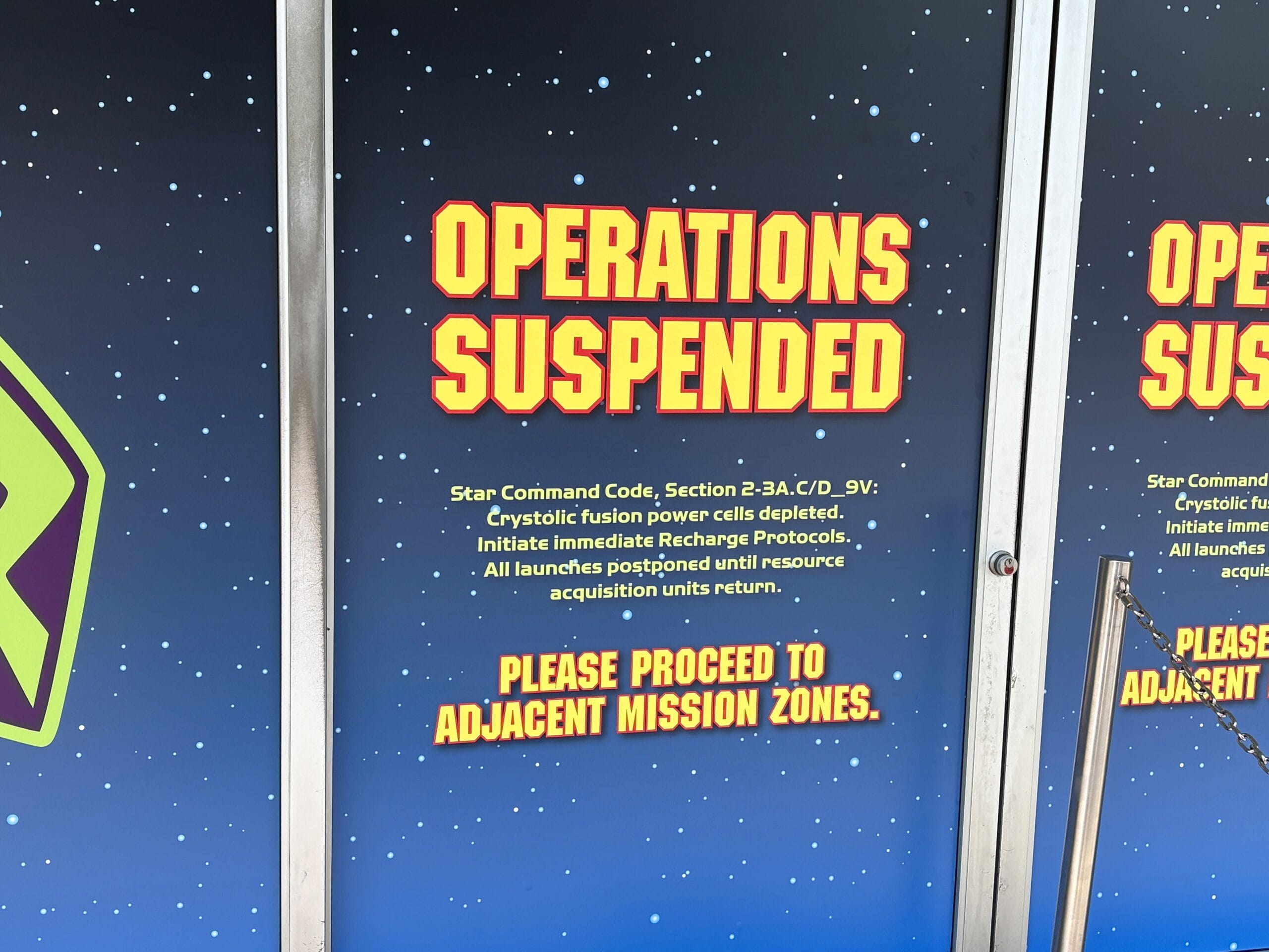 Buzz Lightyear Space Ranger Spin Closure - Blue sign with yellow and red text reading "Operations Suspended. Please proceed to adjacent mission zones.