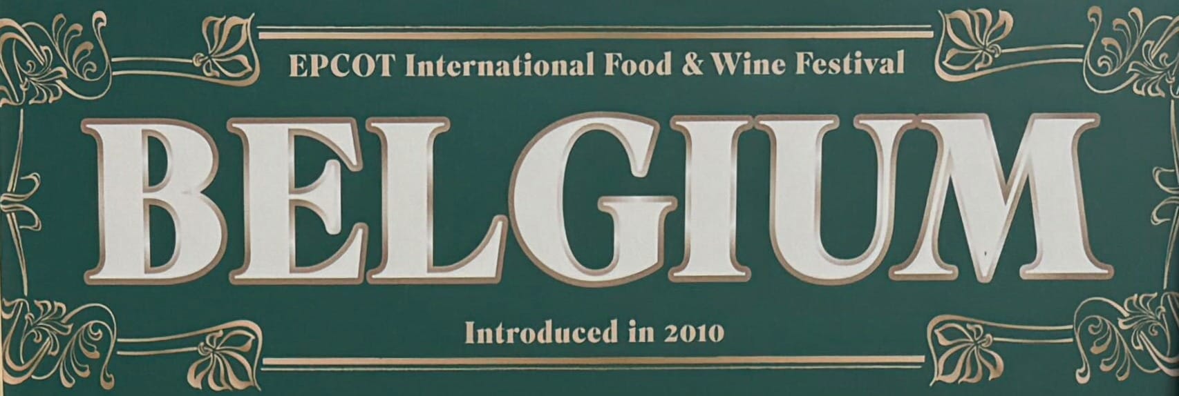 Green sign featuring "EPCOT International Food & Wine Festival BELGIUM Introduced in 2010" in gold and white lettering.