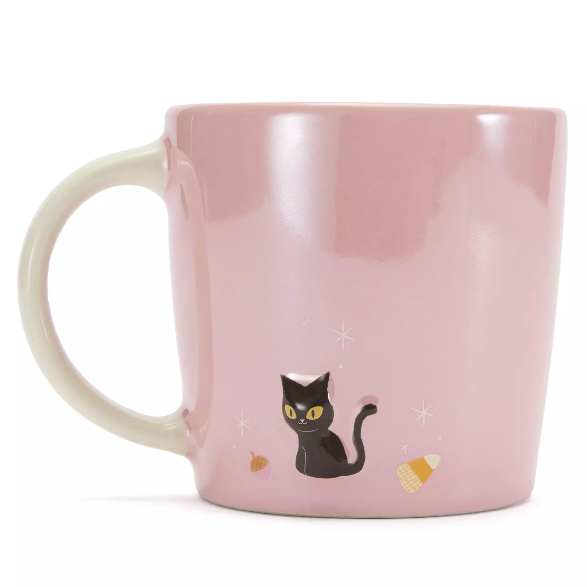 Pink mug with a cream handle, featuring a black cat and small candy corn illustrations near the base.