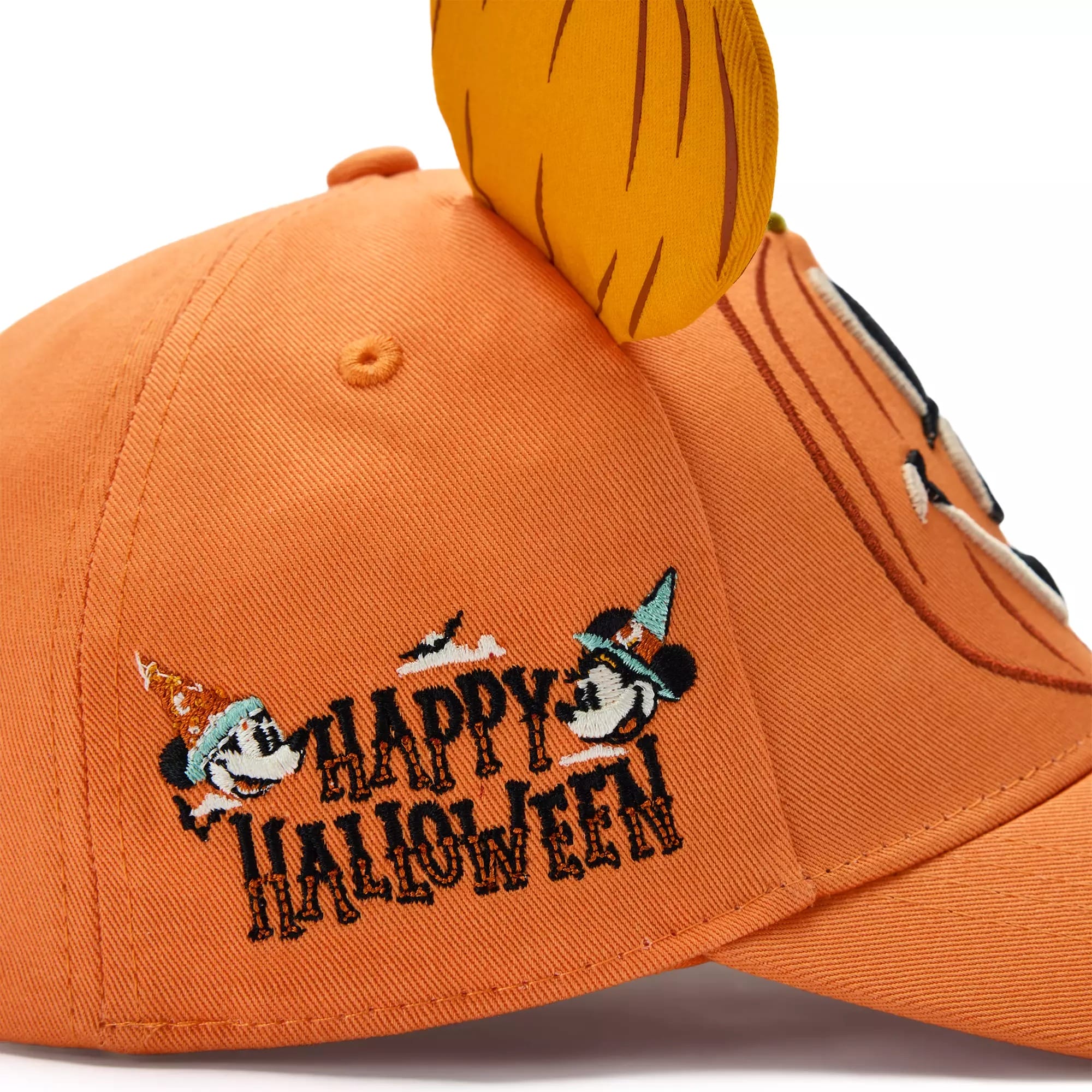 Orange cap from Disney Store with "Happy Halloween" text, cartoon mice in hats, and plush pumpkin stem—festive Halloween apparel.