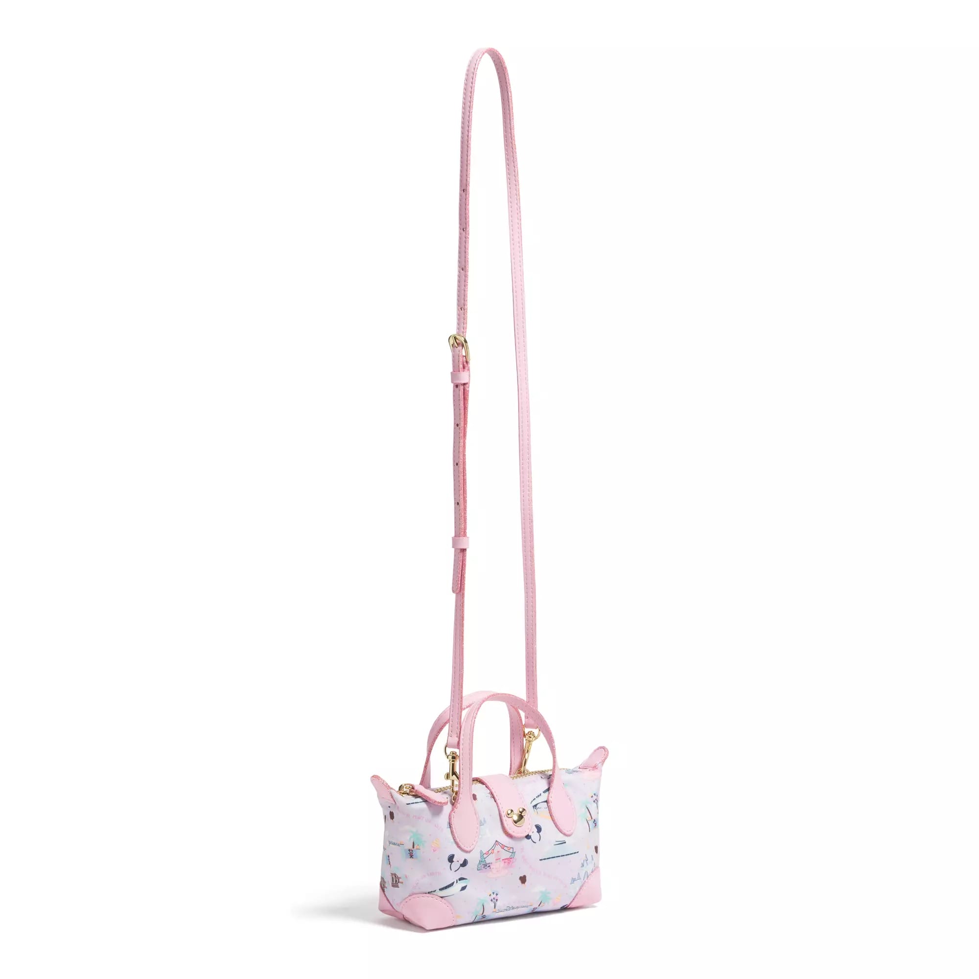 A small pastel pink handbag with a long strap and a playful pattern featuring cats and birds.