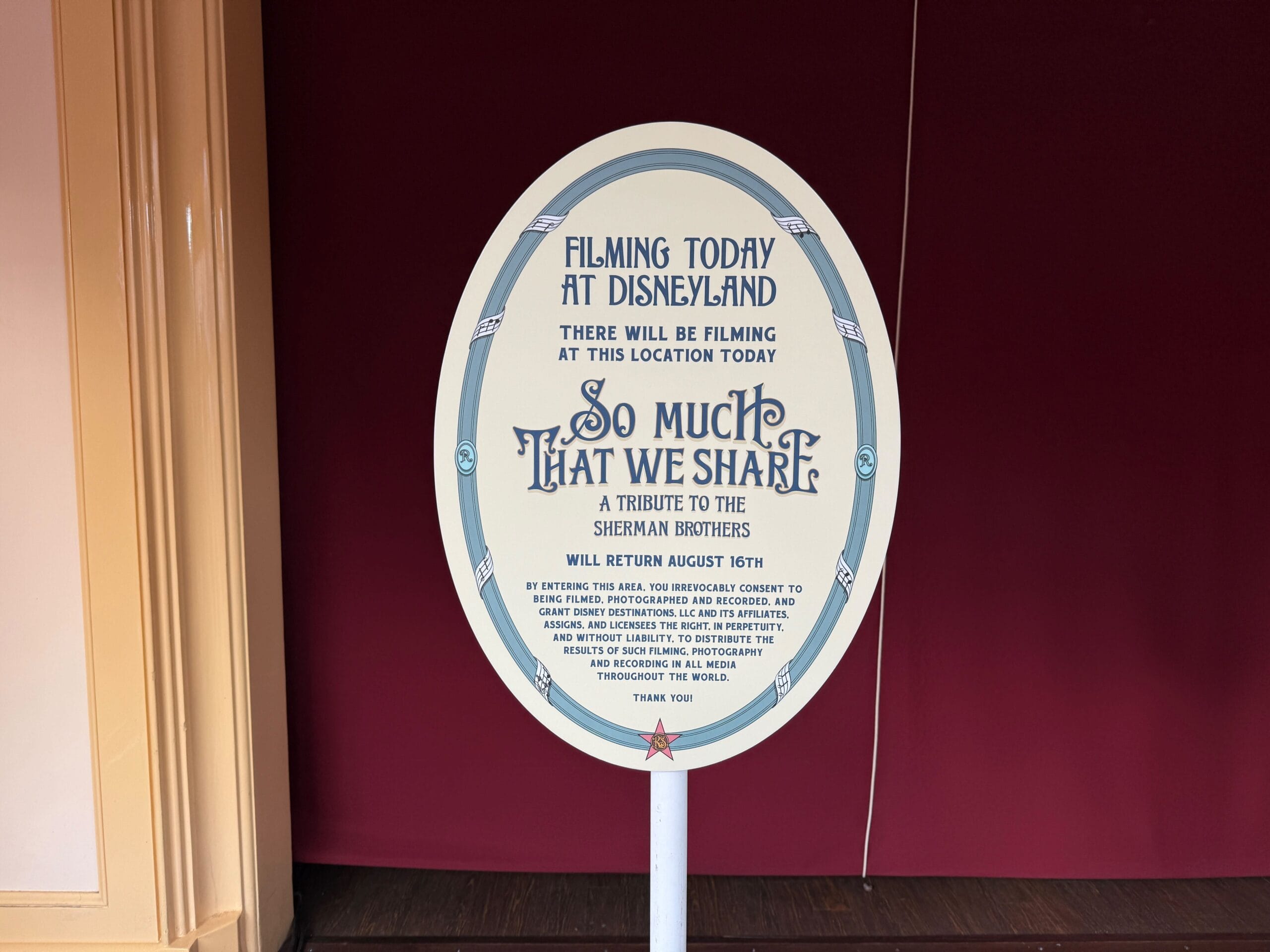 Oval sign at Disneyland announces filming today for "So Much That We Share," a tribute to the Sherman Brothers.
