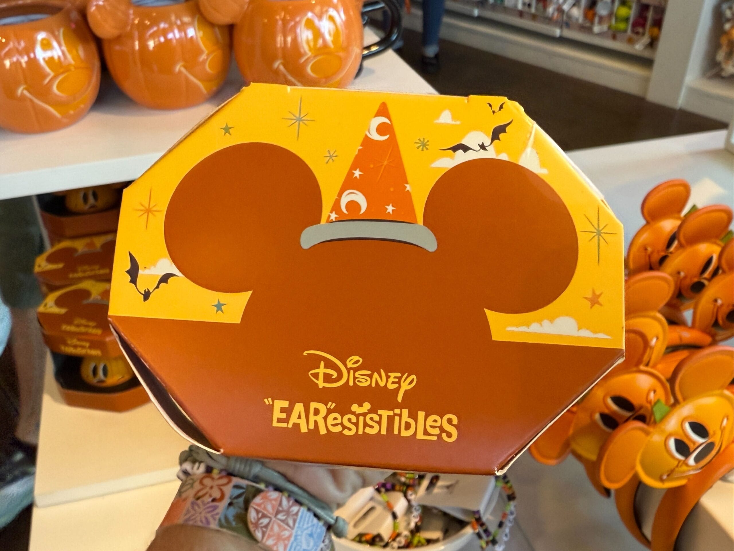 Octagonal Disneyland box with Mickey ears, wizard hat, bats, and stars, labeled "EARresistibles" Halloween merchandise.