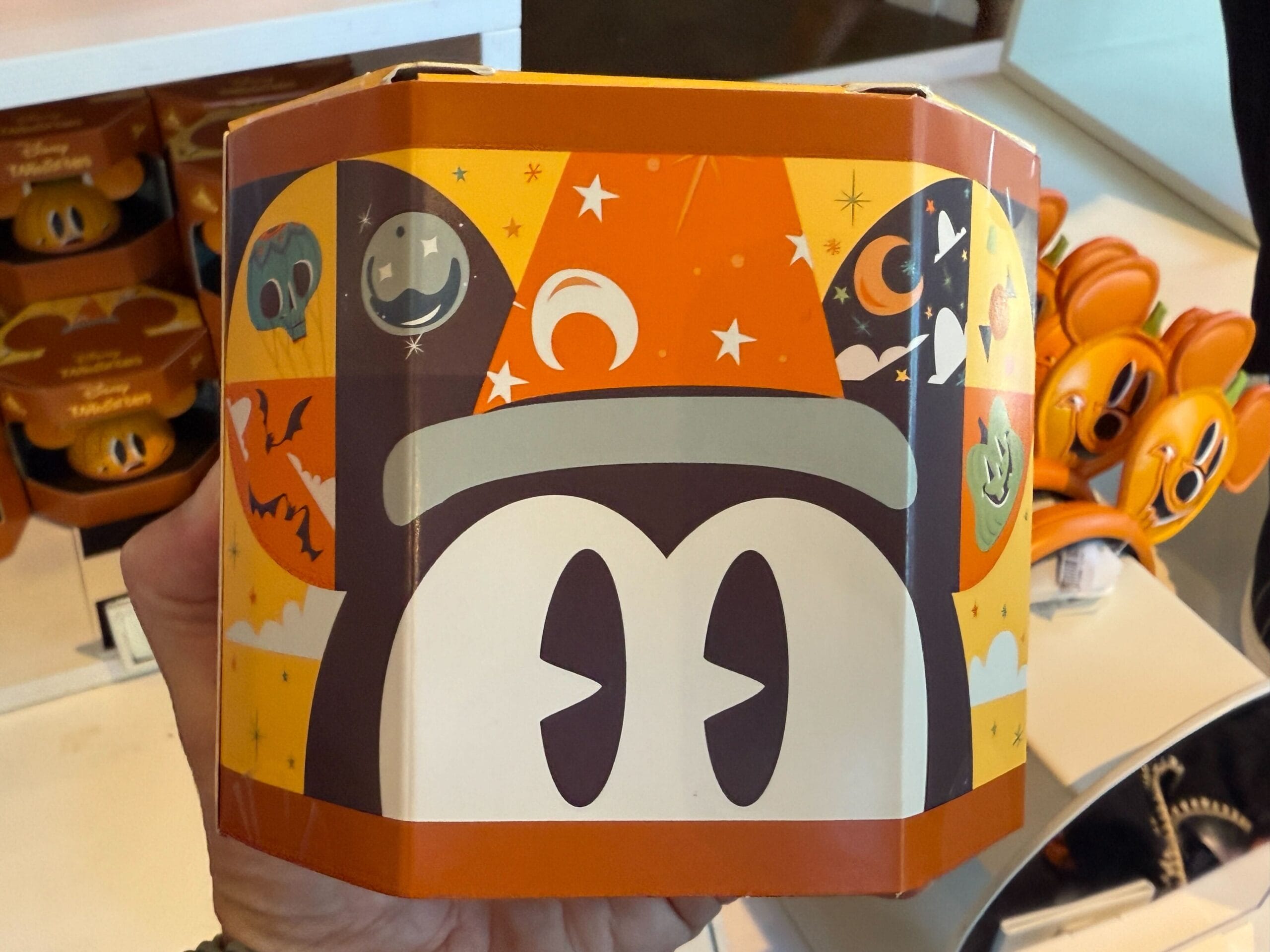 Close-up of Halloween Merchandise: Disneyland Mickey Mouse ears packaging with bats, pumpkins, and stars in orange and black.