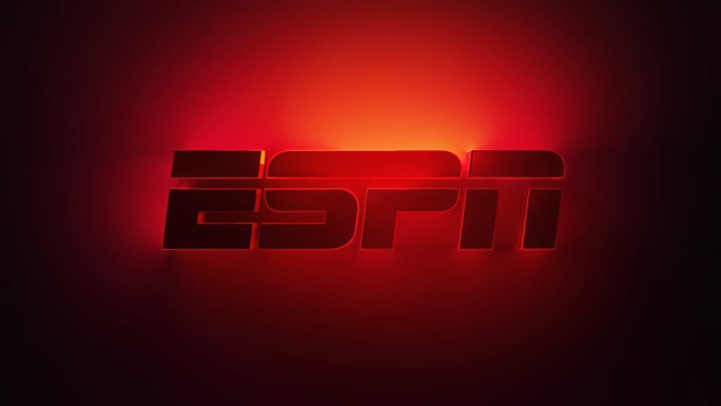 The red ESPN logo glows brightly, highlighting the new ESPN Streaming Service on a dark background.