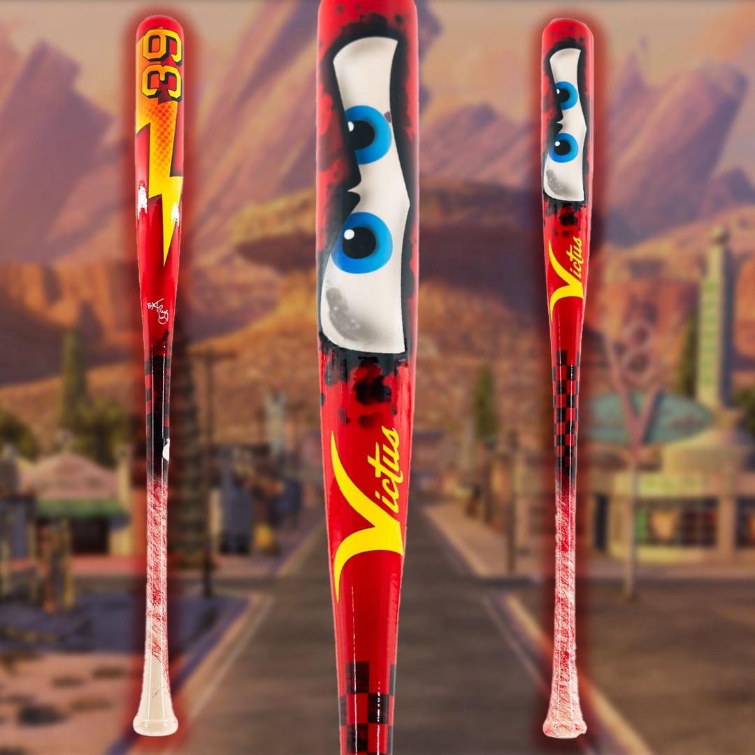 Victus Lightning McQueen Bat with Lightning McQueen cartoon eyes, lightning bolt, and the number 95, set against a blurred Route 66 background from "Cars."