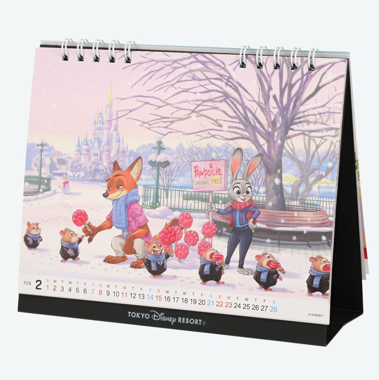 Disney calendar page features Nick and Judy from Zootopia at Tokyo Disney Resort, handing pom-poms to dancing rodents in the snow.