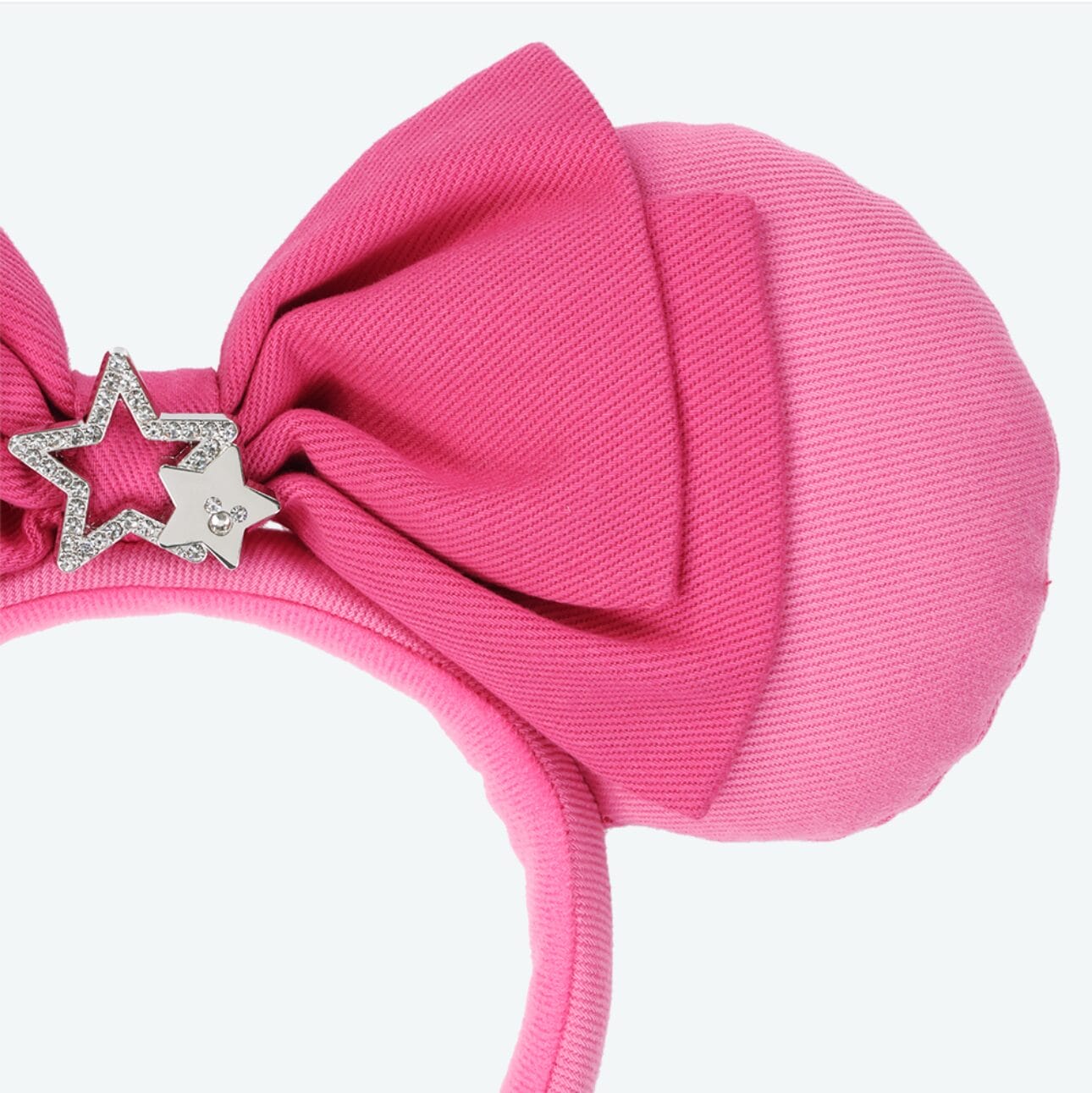 Pink mouse ear headband with a large pink bow, perfect for Tokyo Disney Resort planners and fans alike.