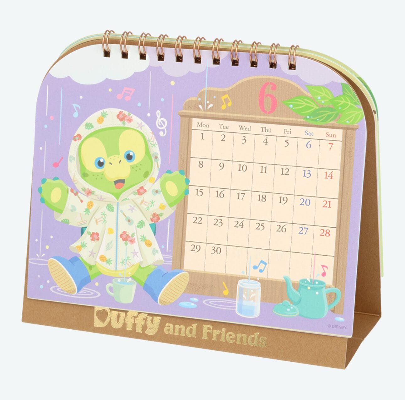 A 2026 calendar for June with a cartoon turtle in a floral raincoat, teacups, and music notes.