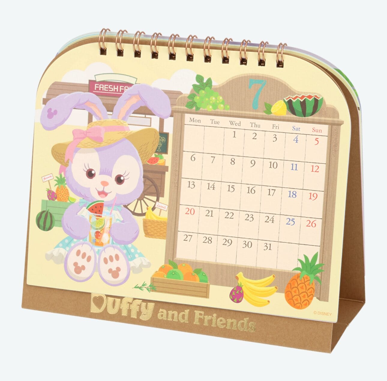 A cute bunny with a sunhat sits by fruit, beside a July calendar from Tokyo Disney Resort on a "Duffy and Friends" display.