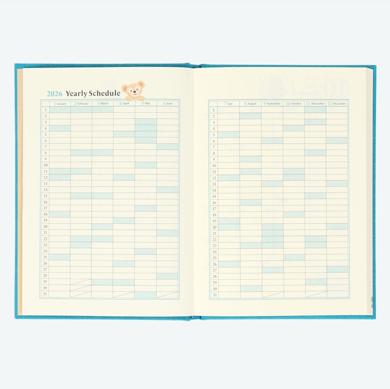 Open planner displaying a 2026 yearly schedule, blank monthly columns, and a Tokyo Disney Resort bear illustration at the top.