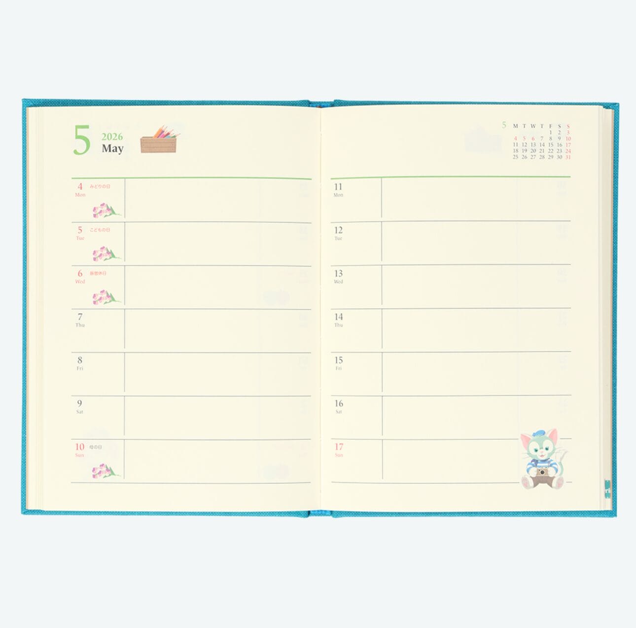 Open planner with May 2026 weekly spread, floral decor, cartoon animal, and Tokyo Disney Resort ear headbands in the corner.