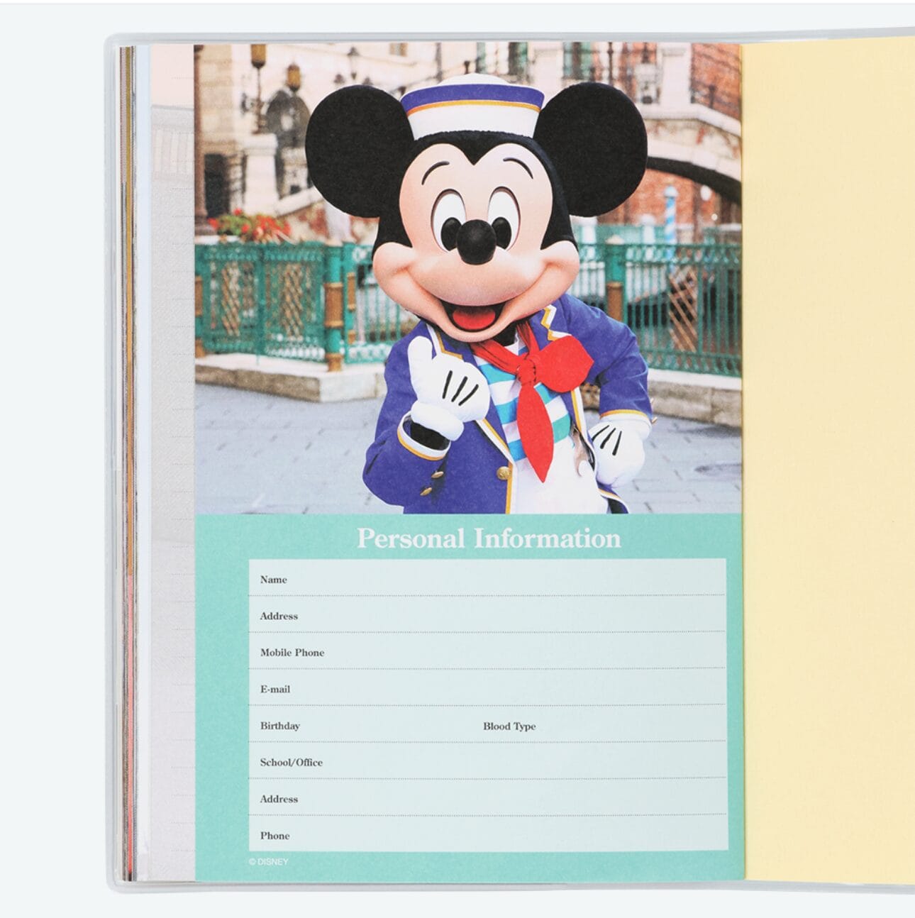 Open book for personal info with Mickey Mouse in a blue uniform, perfect for planners or 2026 calendars at Tokyo Disney Resort.
