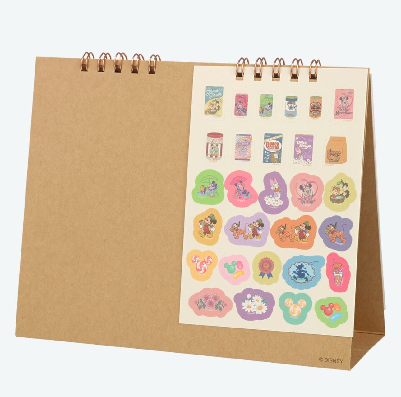 A brown spiral-bound stand displays colorful Tokyo Disney Resort stickers—perfect for planners or 2026 calendars.