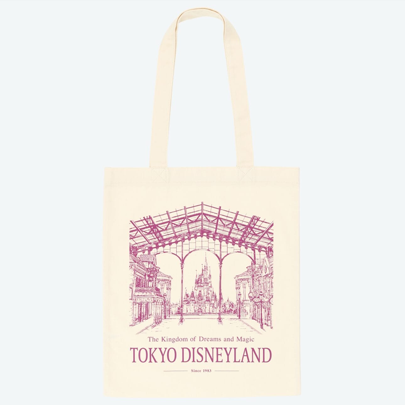 Beige tote bag with a pink line drawing of Tokyo Disney Resort and "The Kingdom of Dreams and Magic TOKYO DISNEYLAND" text.