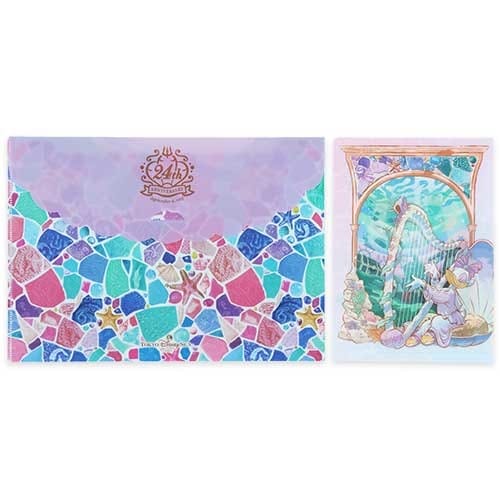 Colorful folder with a mosaic pattern and a card showing a mermaid playing a harp underwater.