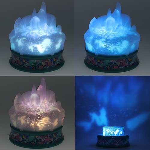 A round, crystal-like lamp glows in blue and purple shades, casting light patterns on the surrounding surfaces.