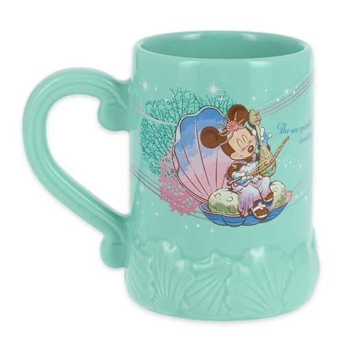 Turquoise mug with Minnie Mouse as a mermaid sitting in a seashell, surrounded by ocean-themed decorations.