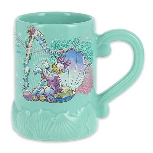 A teal mug featuring Daisy Duck sitting in a seashell playing a harp, with sea-themed designs on the base and handle.