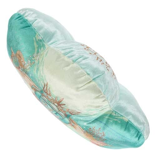 Round, teal and cream pillow with underwater-themed design, featuring coral and shells on soft, shiny fabric.
