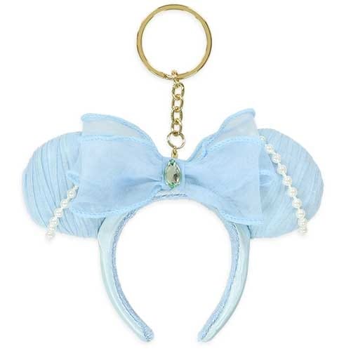 Light blue Minnie Mouse ears headband keychain with a bow, pearls, and a gold keyring attached.