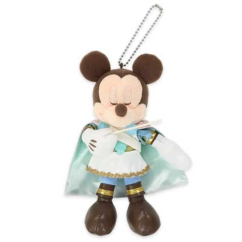 Plush toy of Mickey Mouse wearing a cape and holding a scroll, with a keychain attached to its head.