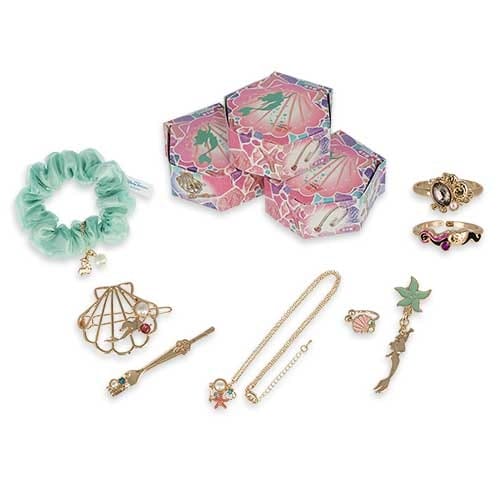 Assorted pastel jewelry, a scrunchie, and three decorative boxes with seashell and mermaid designs arranged on a white background.