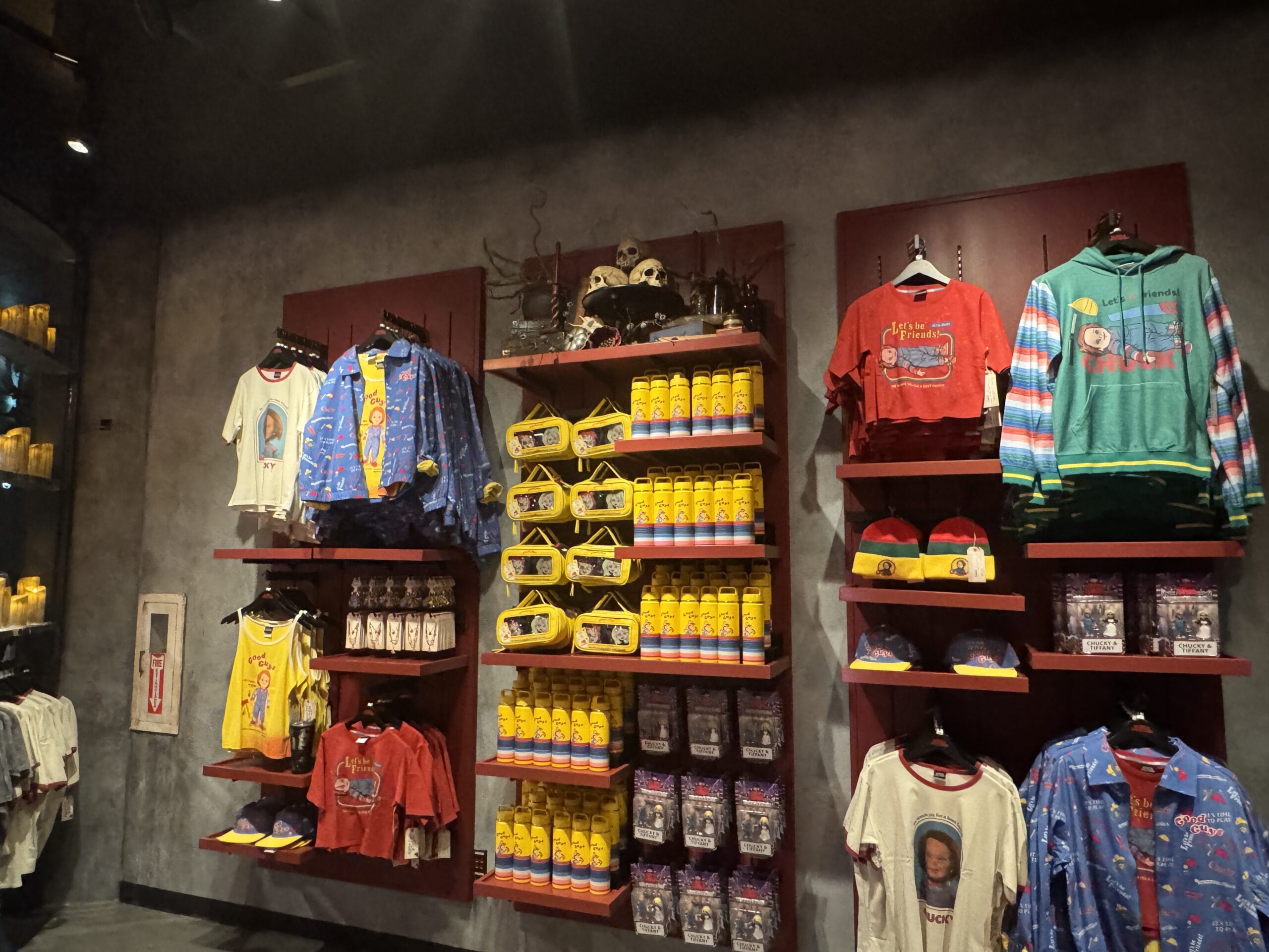 Display of colorful shirts, hoodies, and souvenirs at Universal Horror Unleashed in Las Vegas merchandise store.