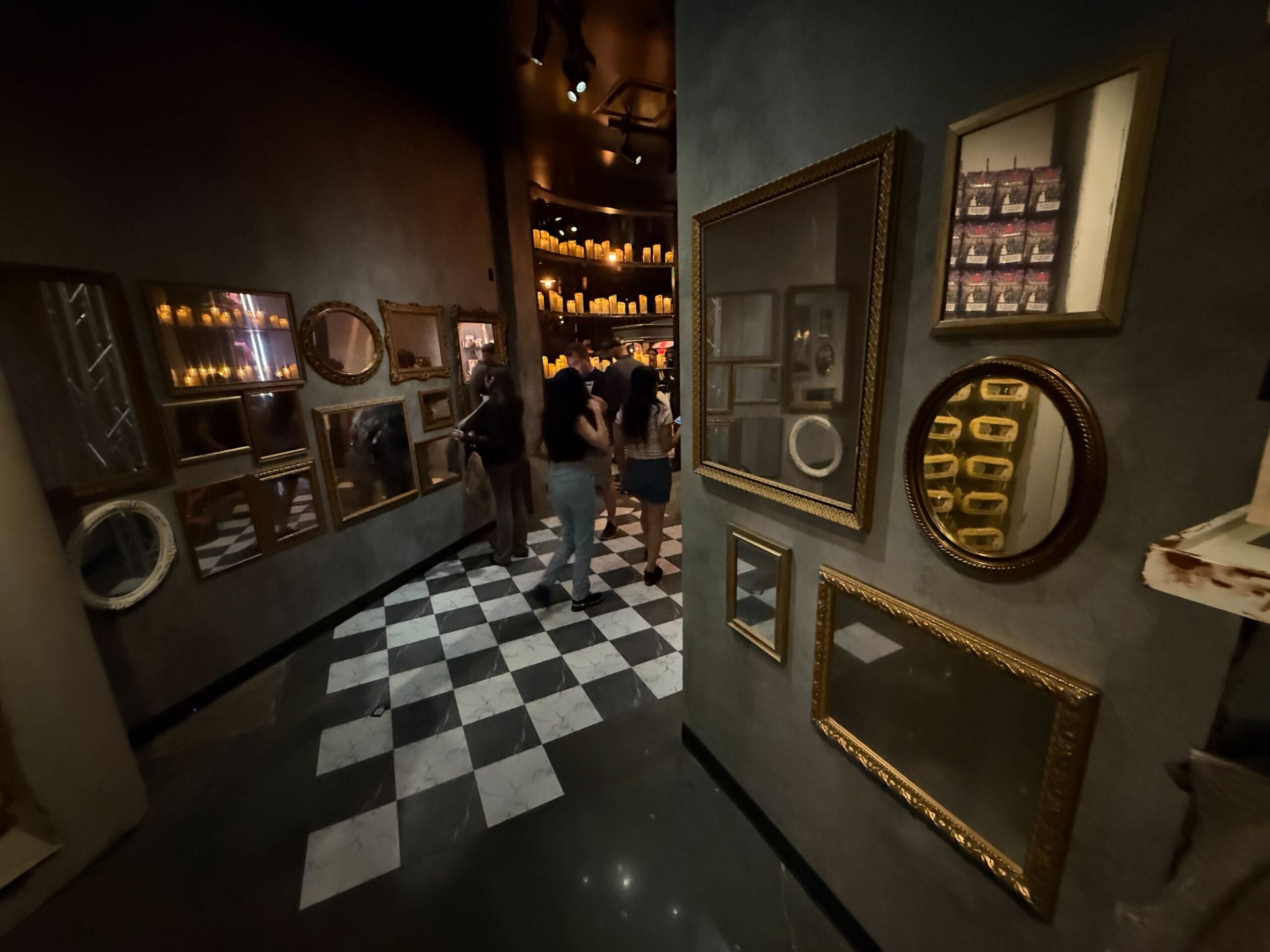 People walk through a dimly lit hallway on the full tour of Universal Horror Unleashed in Las Vegas.