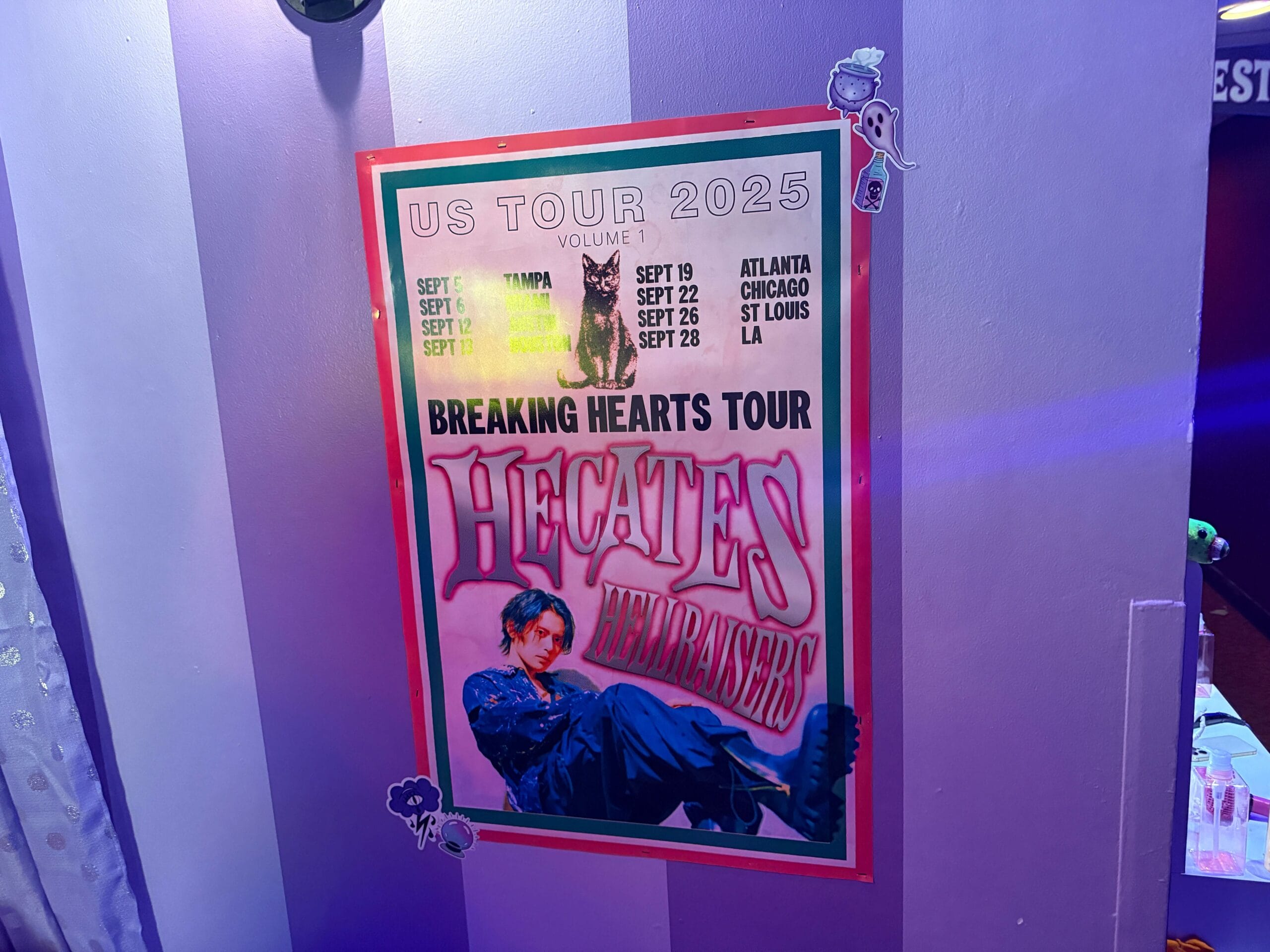Poster on a purple wall for Sorority Witches' "Breaking Hearts Tour" at Dead Coconut Club—2025 US dates and cities listed.