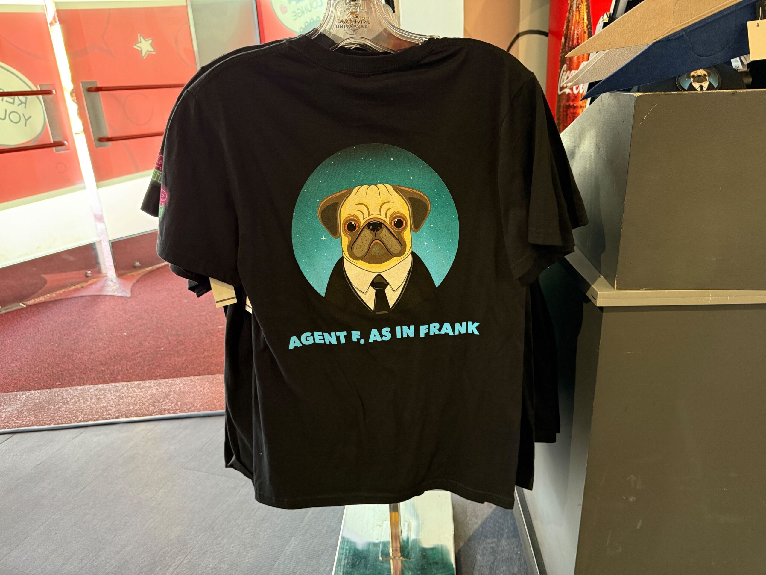 Black t-shirt with an illustration of a pug in a suit and the text "AGENT F, AS IN FRANK" below the image.