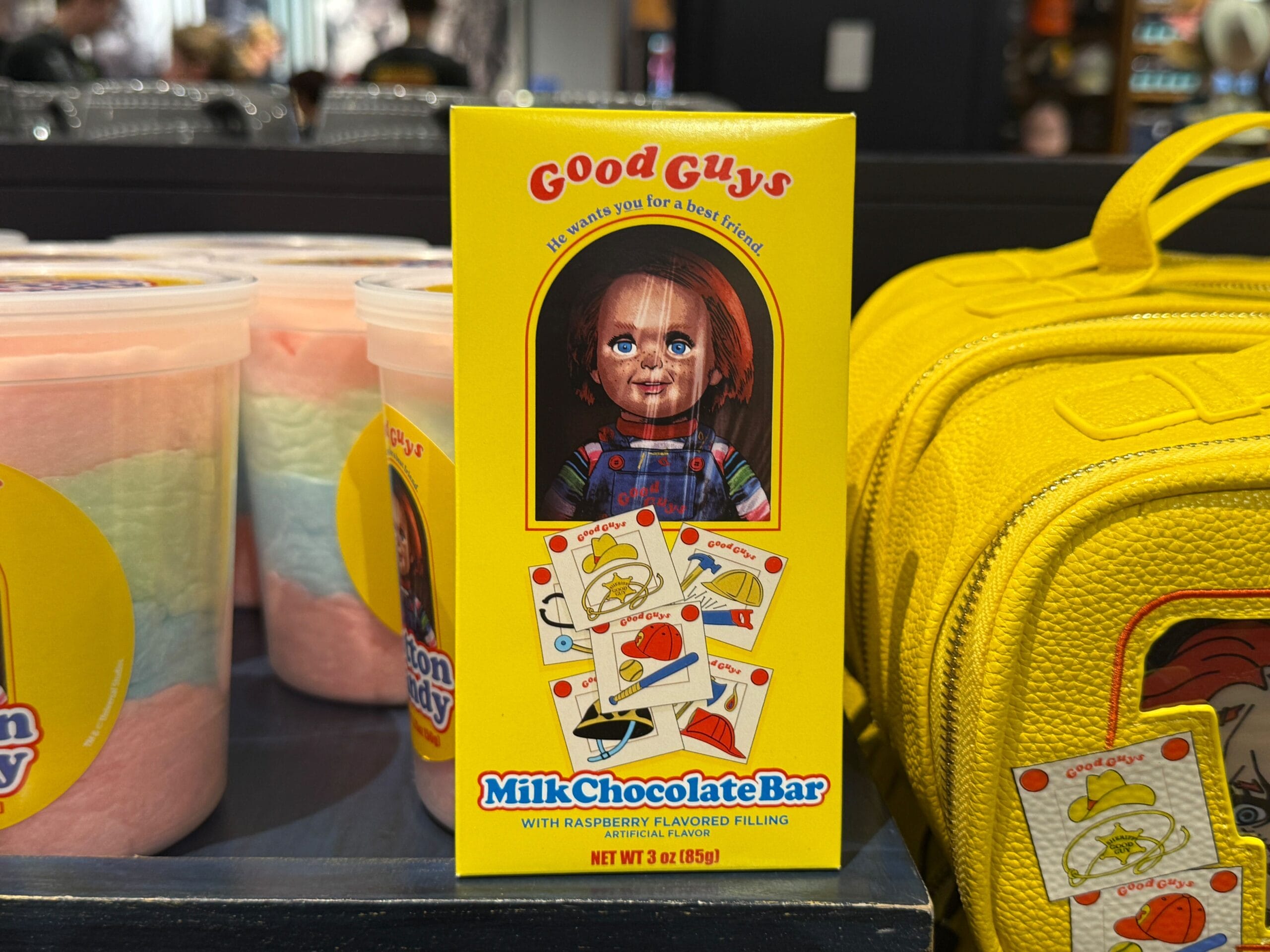 A "Good Guys" milk chocolate bar box with Chucky, playing cards, and bright colors from HHN Merch 2025 at Universal Orlando Resort.