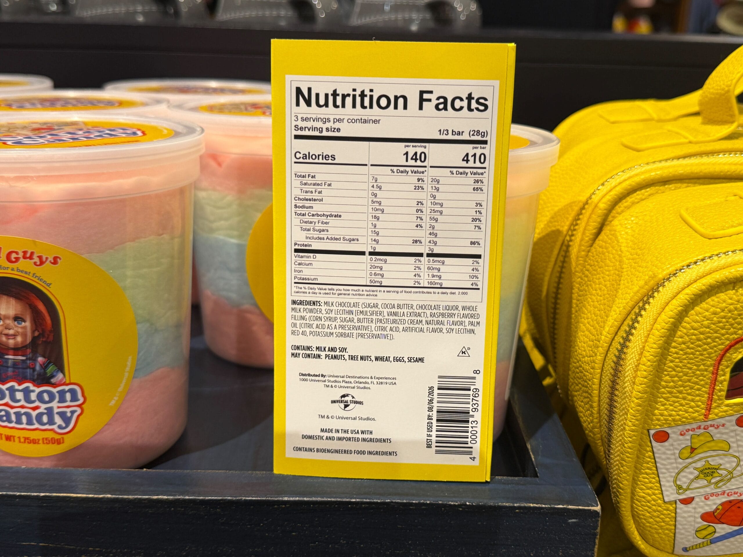 A yellow nutrition facts label for cotton candy sits by Halloween Horror Nights Merchandise at Universal Orlando Resort.