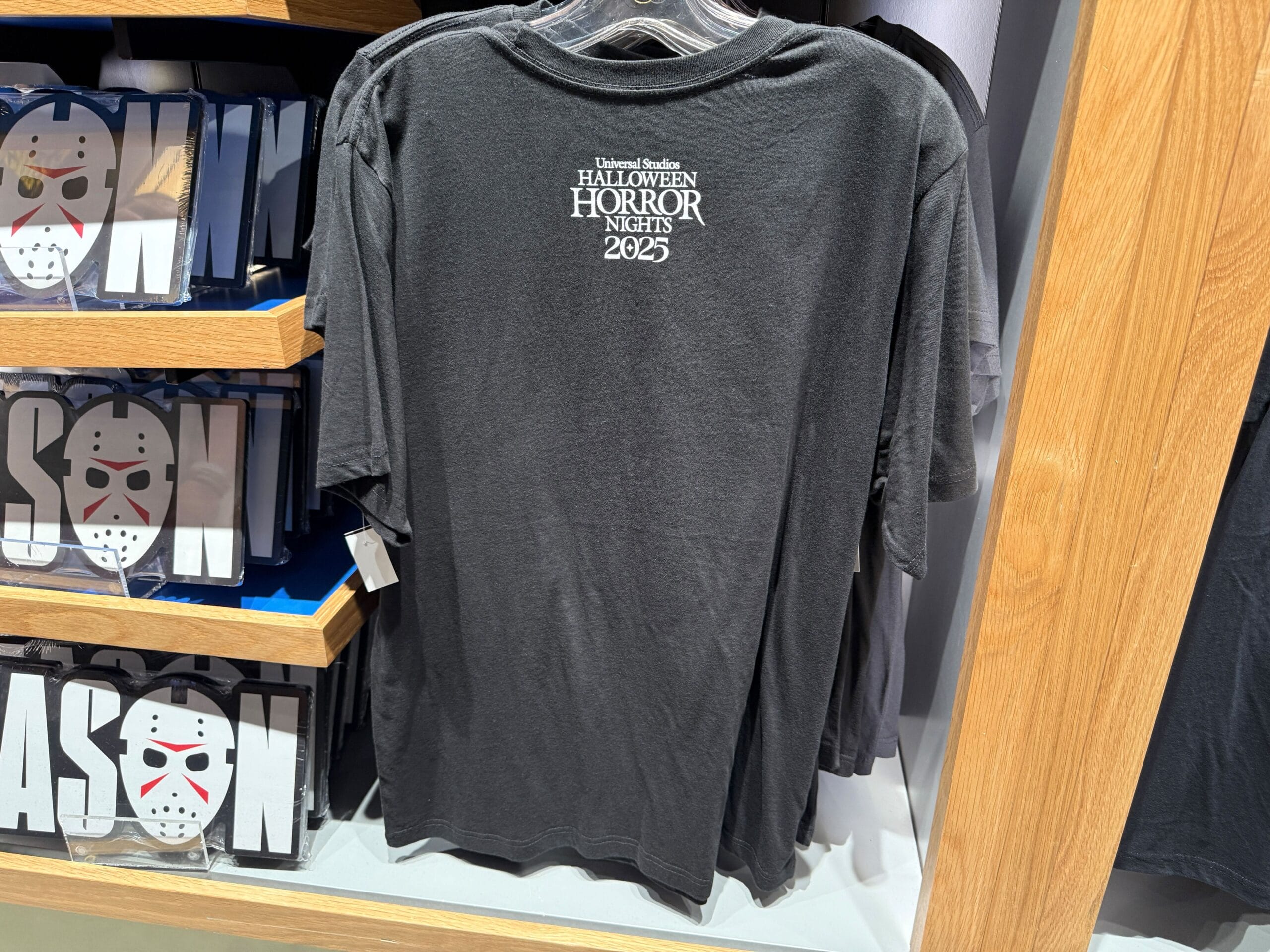 Black T-shirt from Universal Orlando Resort’s Halloween Horror Nights 2025, displayed on a store rack.