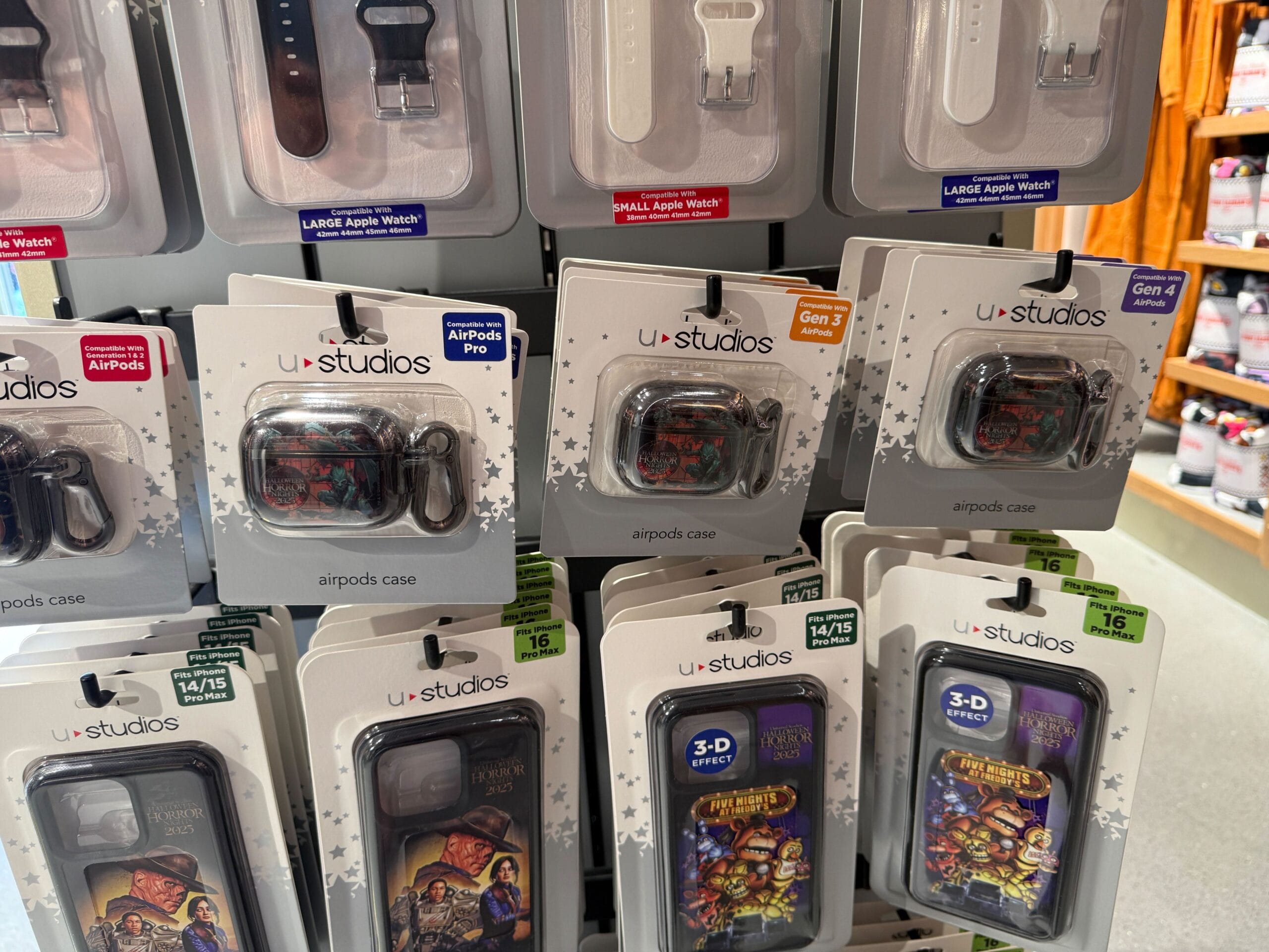 Display of U-Studios AirPods and phone cases with Disney designs, plus HHN Merch inspired by Universal Orlando Resort.