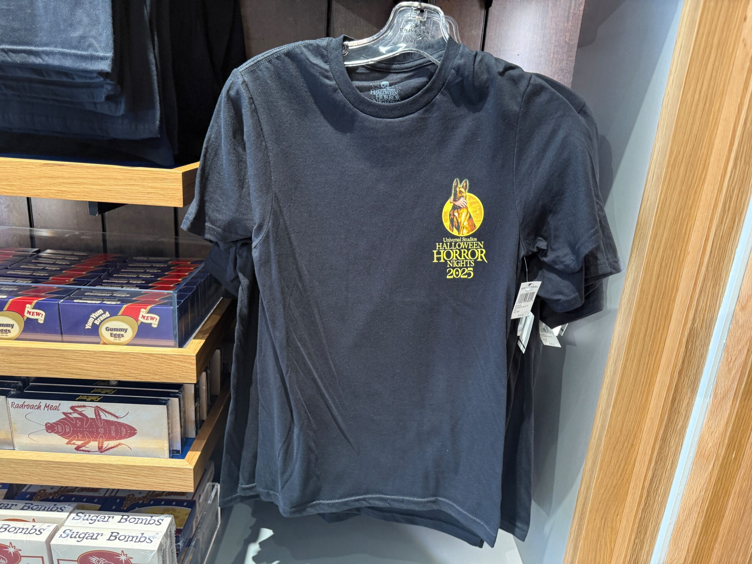 Black T-shirt with "Halloween Horror Nights 2023" yellow logo, classic HHN merch at Universal Orlando Resort.