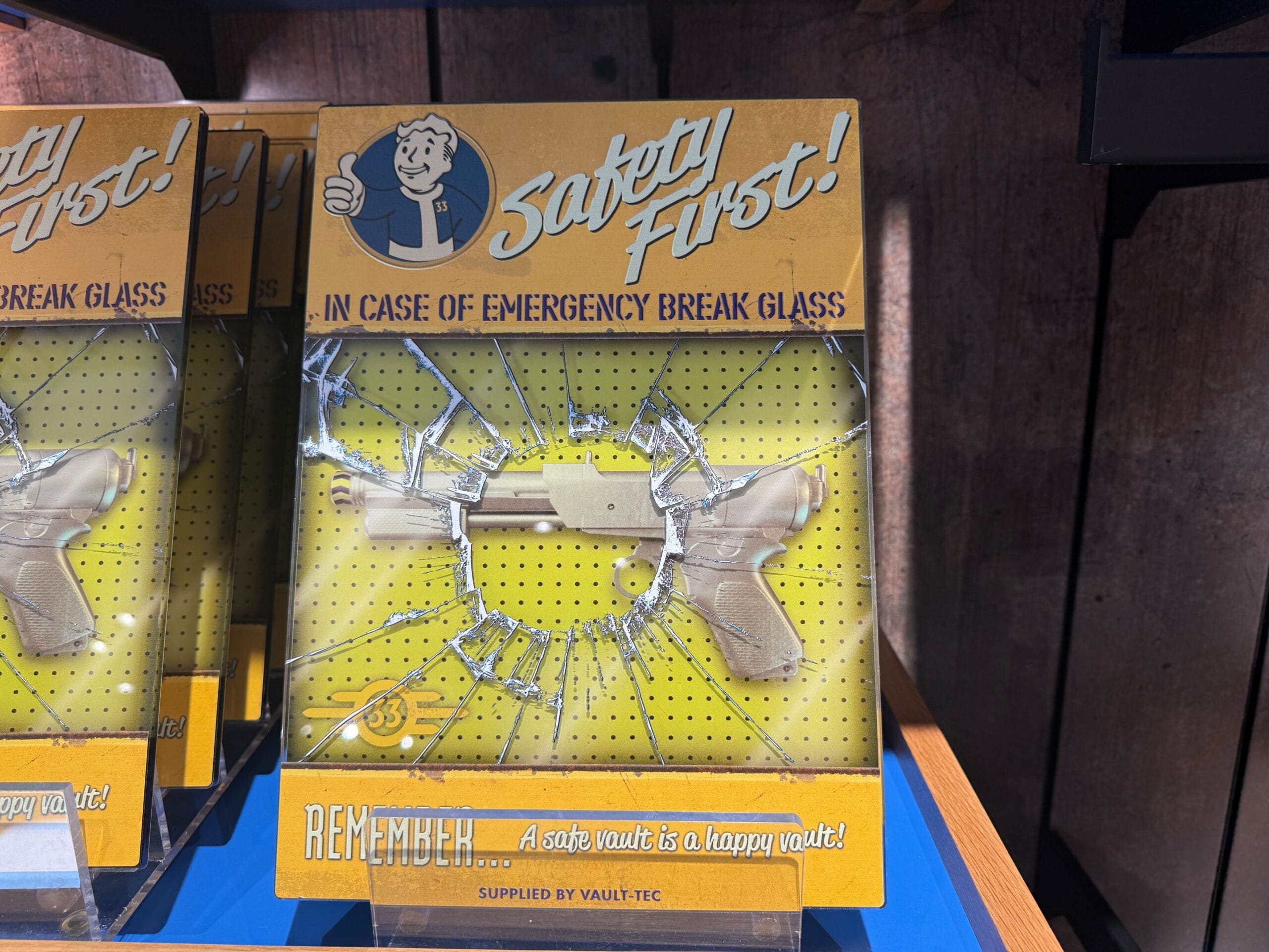 Toy pistol in "Safety First!" packaging, faux broken glass—perfect HHN merch for Halloween Horror Nights 2025.