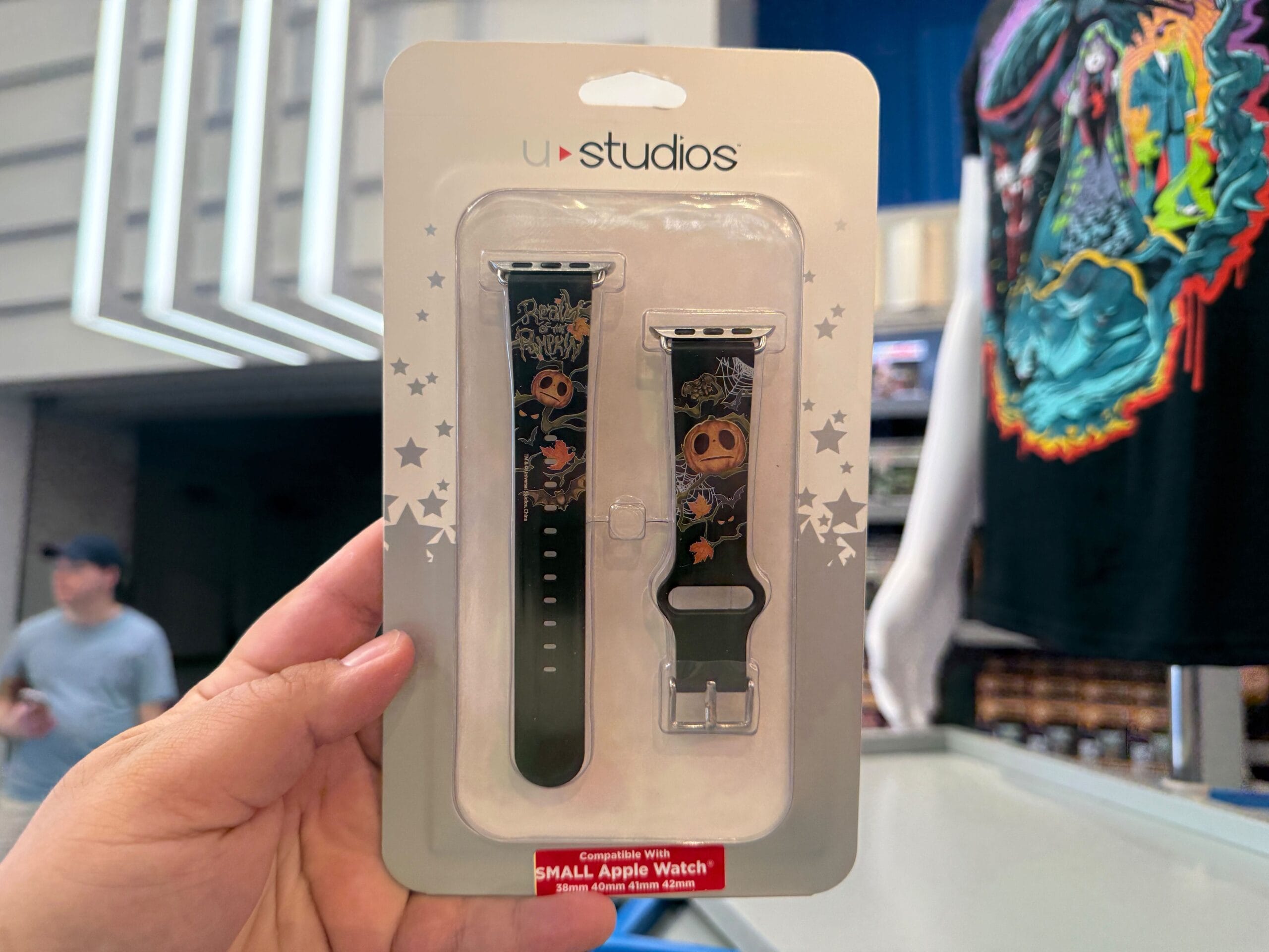 Hand holding a Nightmare Before Christmas Apple Watch band set—HHN Merch spotted at Universal Orlando Resort.