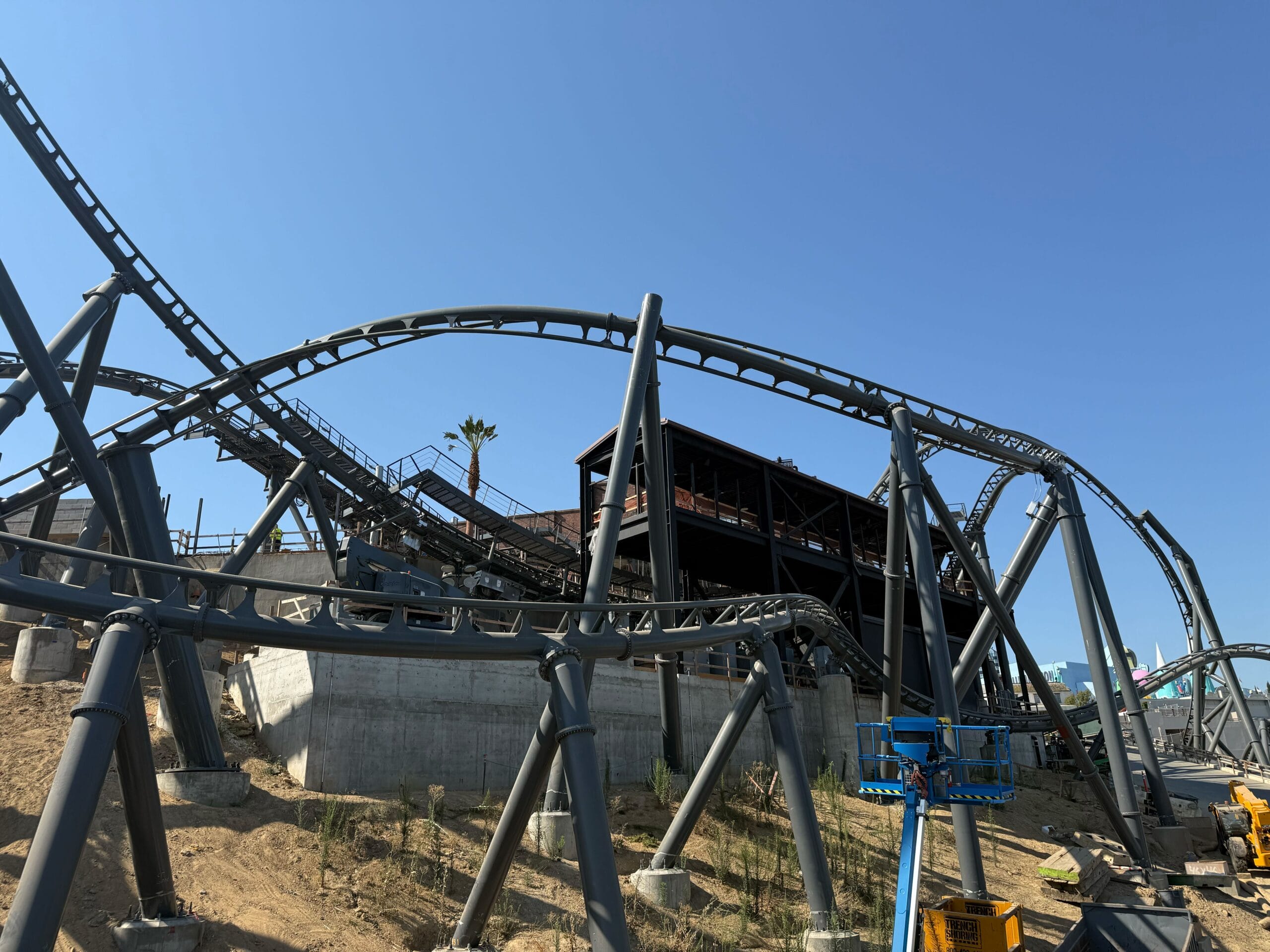 A steel roller coaster under construction at Universal Studios Hollywood with a clear blue sky in the background.
