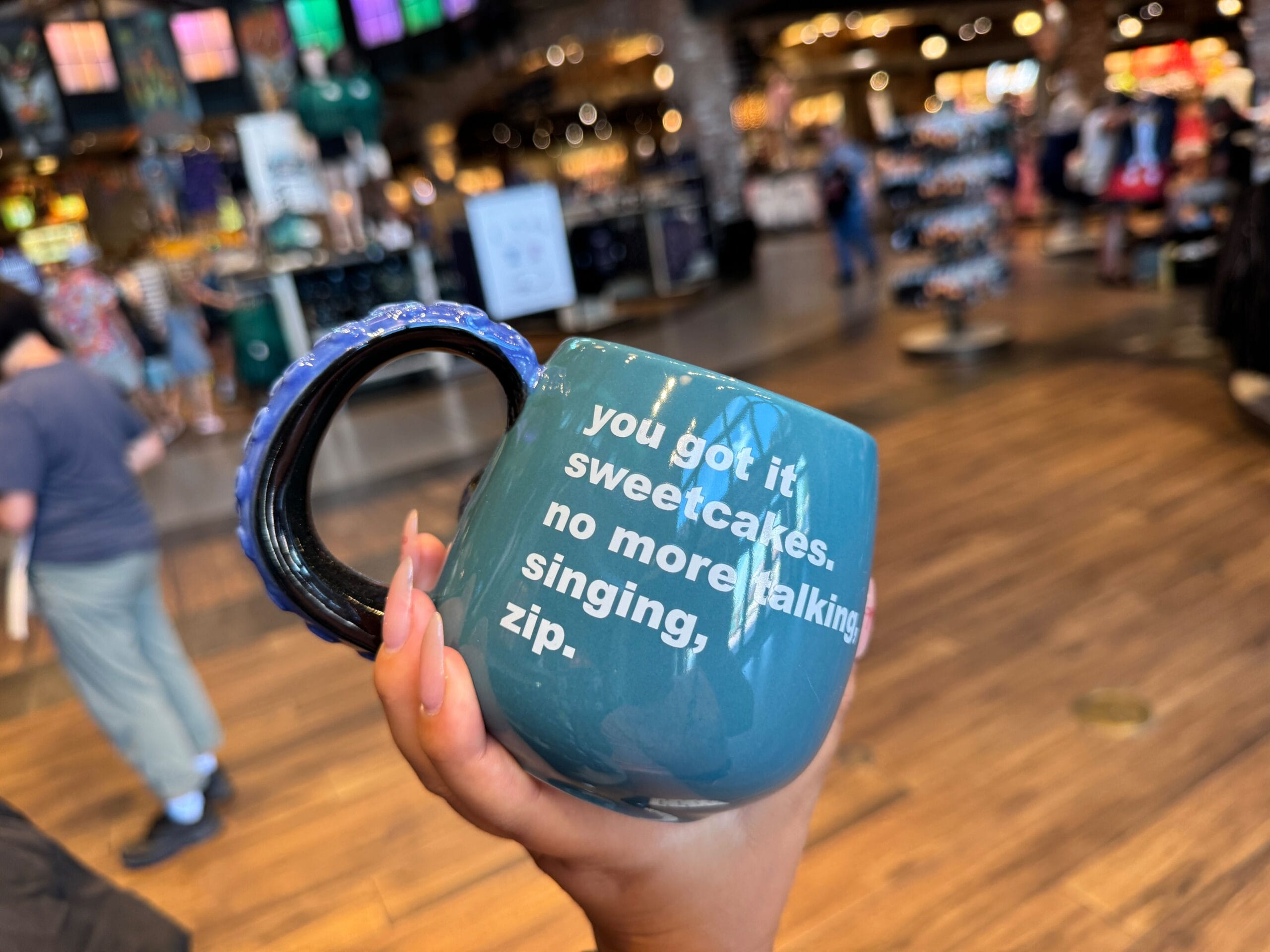 Hand holding a blue mug—perfect for Halloween 2025 or Disney Villains merchandise collectors.